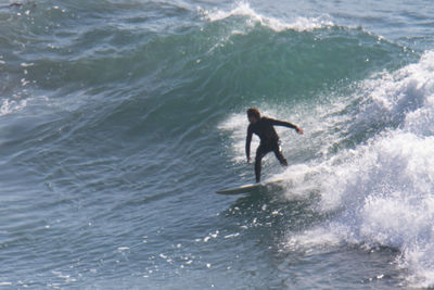 Full length of man surfing in sea