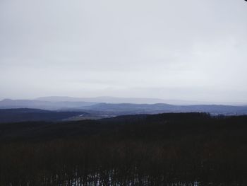 Scenic view of field and mountains against sky