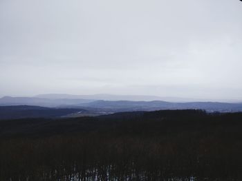 Scenic view of field and mountains against sky