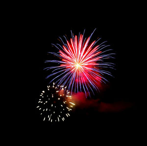 Low angle view of firework display at night