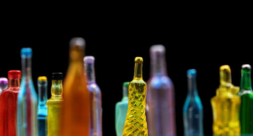 Various miniature bottles of alcohol without labels with black bacground