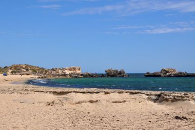 Scenic view of rocks in sea against sky at cape peron