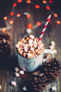 High angle view of christmas decorations with marshmallows in cup on table