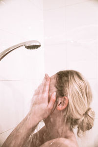 Close-up of young woman in bathroom