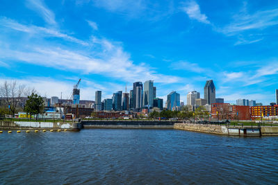 River and cityscape against blue sky