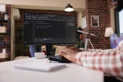 Midsection of man using laptop at office