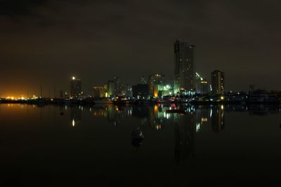 Reflection of buildings in city at night