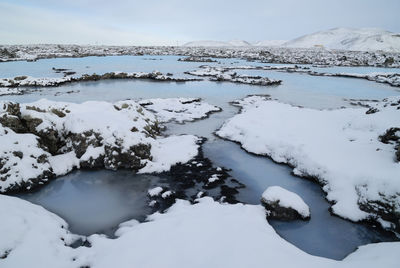 Scenic view of frozen lake against sky