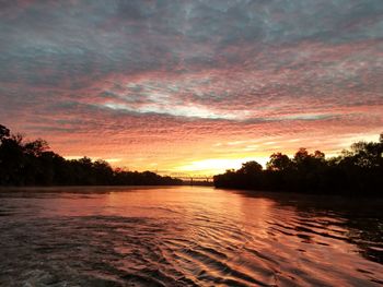 Scenic view of lake against orange sky