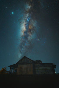 Low angle view of abandoned building against sky at night