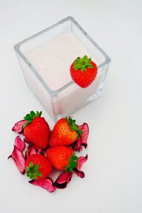 Close-up of strawberry over white background