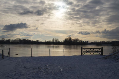 Scenic view of lake against sky during sunset