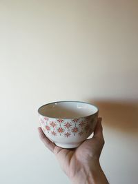 Cropped hand holding coffee cup