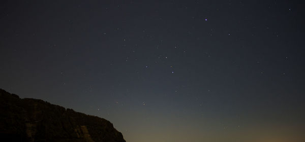 Low angle view of mountain against sky at night