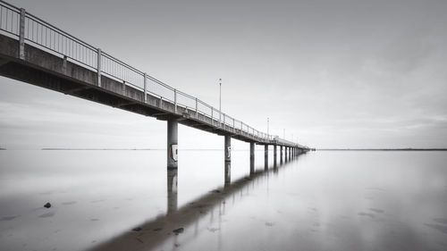 Bridge over water against sky