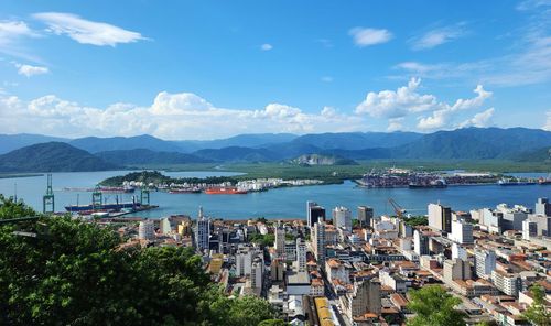High angle view of townscape by sea against sky