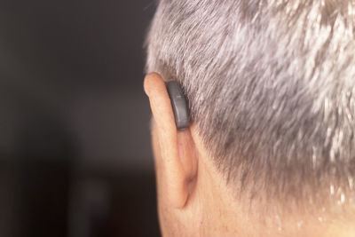 Close-up of man with hearing aid