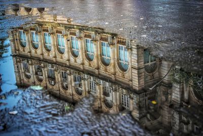 Reflection of building in puddle