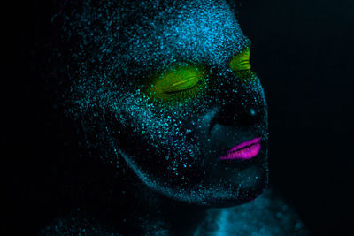 Woman with eyes closed in neon make-up