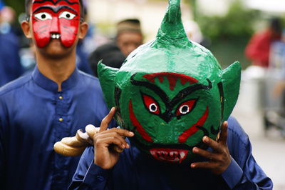 Portrait of people holding mask