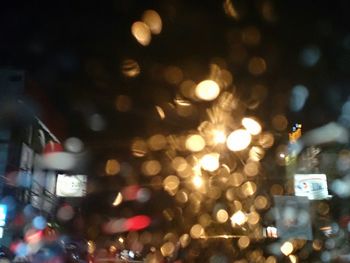 Defocused image of illuminated city street at night