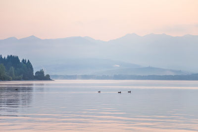 A beautiful sunrise over the lake with mountains in distance. morning landscape in warm tones.