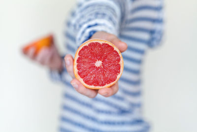 Midsection of man holding strawberry