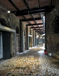 Empty road amidst buildings