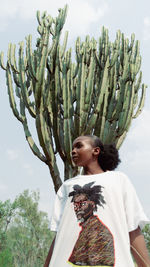 Rear view of woman standing against sky