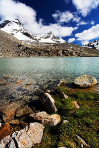 Scenic view of river by mountains against sky at gran paradiso national park