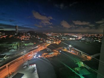 High angle view of illuminated street amidst buildings in city