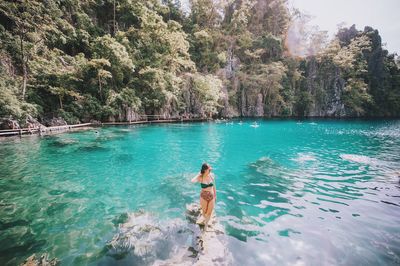 Woman in kayangan lake at coron island