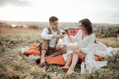 Young couple sitting on land