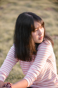 Side view of cute girl looking down