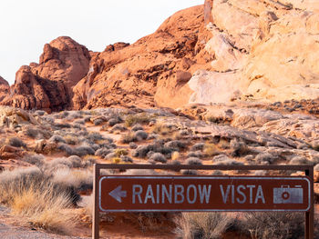 Information sign on rock against sky