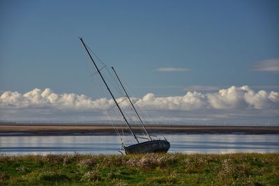 Sailboat on sea against sky