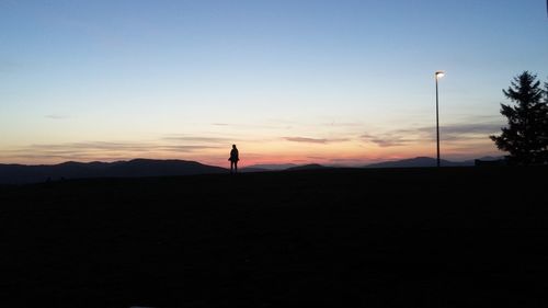 Silhouette of person against sky during sunset