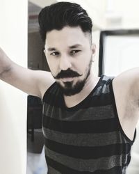 Portrait of man standing at home