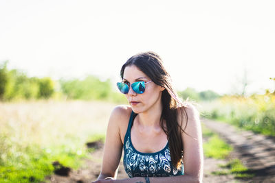 Young woman wearing sunglasses on field