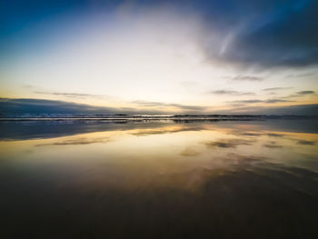 Scenic view of sea against sky at sunset