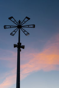Low angle view of communications tower against sky during sunset