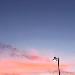 Low angle view of street light against blue sky