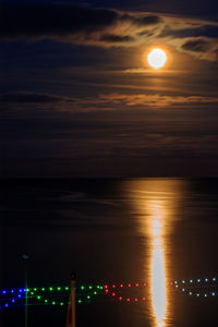 Scenic view of sea against full moon at night