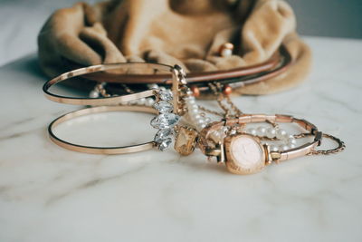 Close-up of jewelry by purse on table