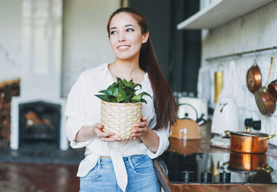 Portrait of a smiling young woman holding ice cream