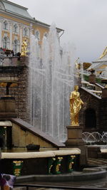Statue against built structure