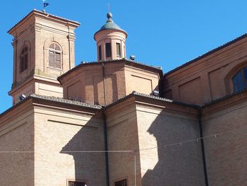 Low angle view of church against clear blue sky