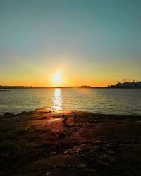 Scenic view of sea against clear sky during sunset