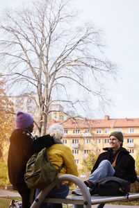 Three friends in park in autumn scenery