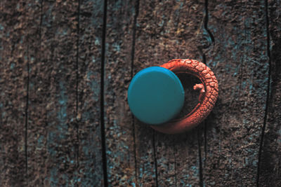 Close-up of rubber band on wooden weathered wall